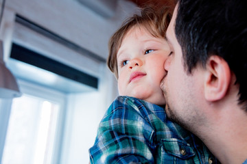 Portrait father and son at home.