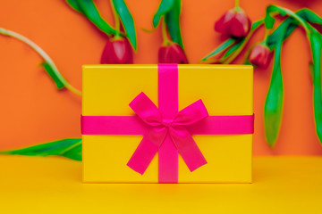 Gift box with bow and tulips