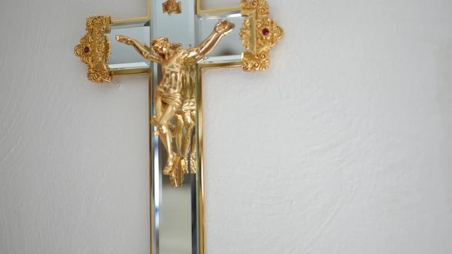 Camera pans over a crucifix in living room