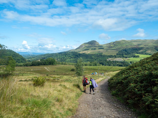 two girls hiking in sunny weather in scotland