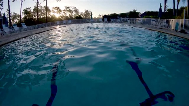 Slow motion POV footage swimming in a Florida community swimming pool.