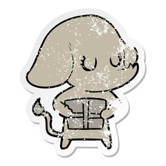distressed sticker of a cute cartoon elephant with gift