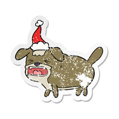 distressed sticker cartoon of a dog barking wearing santa hat