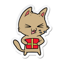 sticker of a cartoon hissing cat with christmas present