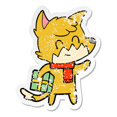distressed sticker of a cartoon happy fox with gift