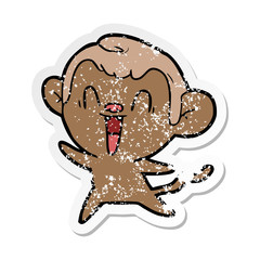 distressed sticker of a cartoon laughing monkey