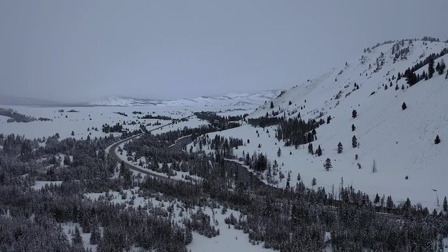 Snowy wilderness and roadway, captured in 4K UHD aerial footage.  Great for story telling, themed presentations or quality B-Roll.