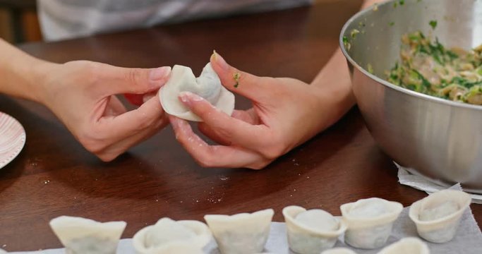 Woman make with chinese meat dumpling