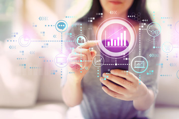 Marketing concept with woman using her smartphone in a living room