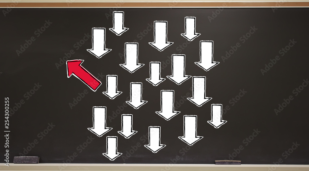 Poster Arrow going in a different direction on a blackboard with erasers