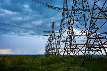  high-voltage  power lines at storm clouds.