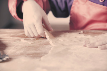 Obraz na płótnie Canvas Child girl chef is making a cakes. The concept of homemade pastry. Selective focus on the hands.