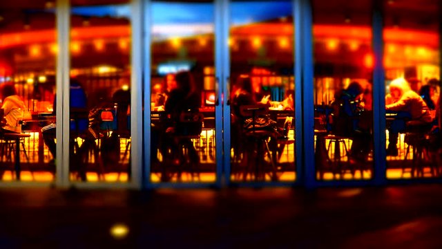 Defocused Time Lapse People Resting In Picturesque Cafe. Panning Shot