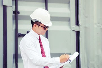 Man in white shirt wears white safety helmet.The most common color scheme is white for managers, architects, engineers, foremen or supervisors. 