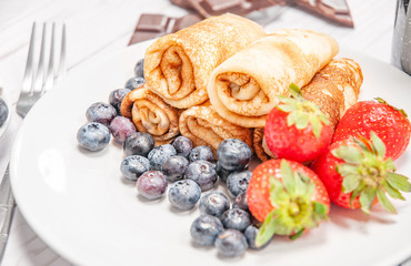 Healthy breakfast, coffee and homemade pancakes with fresh berries and banana