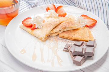 Healthy breakfast. Black tea and delicious pancakes, with fresh berries and chocolate