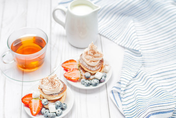 Healthy breakfast, black tea and  homemade pancakes with fresh berries
