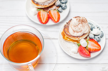 Healthy breakfast, black tea and  homemade pancakes with fresh berries