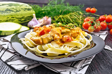 Pasta with goulash in plate on wooden board