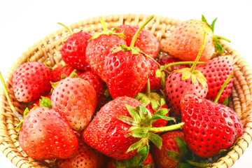 Ripe strawberry on basket isolated on white background