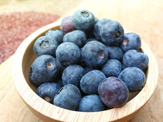 Fresh blueberries in wooden bowl