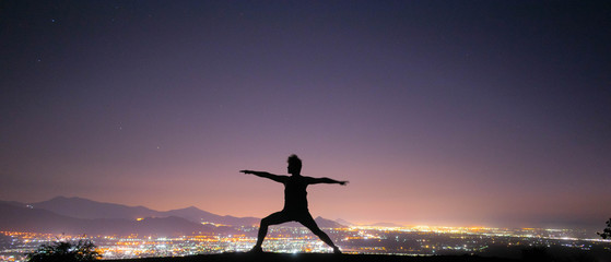 Man traveling the world, practicing yoga in the mountains, sunsets