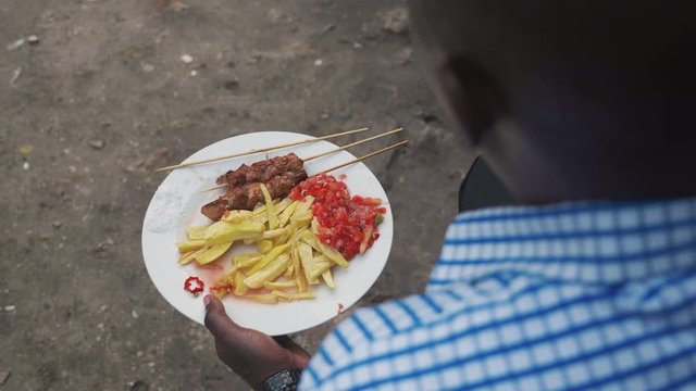 A Man Eating A Local African Street Food In Dar Es Salaam Tanzania