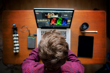 male producer edit video on his laptop in studio b