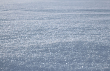 winter white snow cover of sparkling snowflakes with shiny frozen ice on the surface