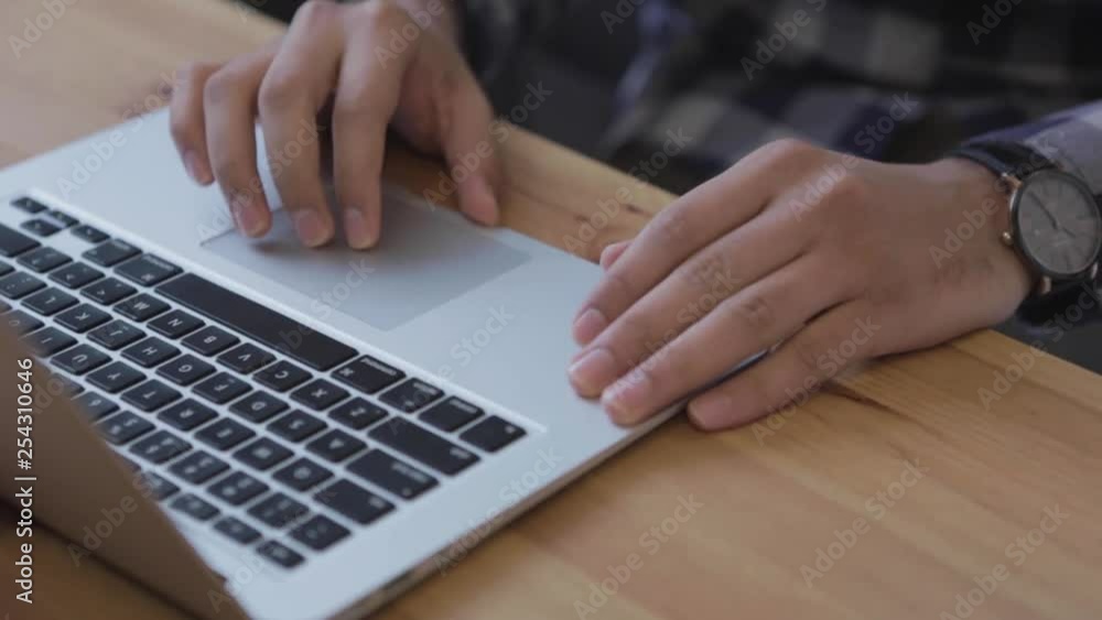 Aufkleber close up of a laptop computer on a table with hands working solely on the touchpad moving and shifti