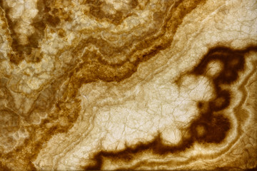 Polished wall mounted backlit tile of beige onyx stone veneer