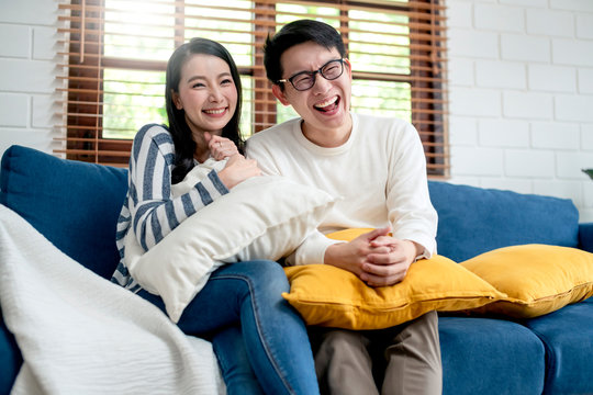 happiness asian sweet couple enjoy tv program show on television together living room home background