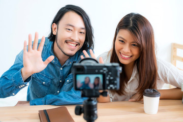 asian couple blogger enjoy communication lives with camera house background concept