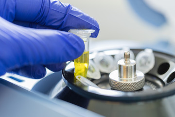 Scientist loading a sample to centrifuge, Concept science and Technology