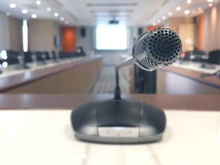 Before a conference, The microphones in front of empty chairs in business forum Meeting or Conference Training Learn Coaching Room Concept, Blurred background.