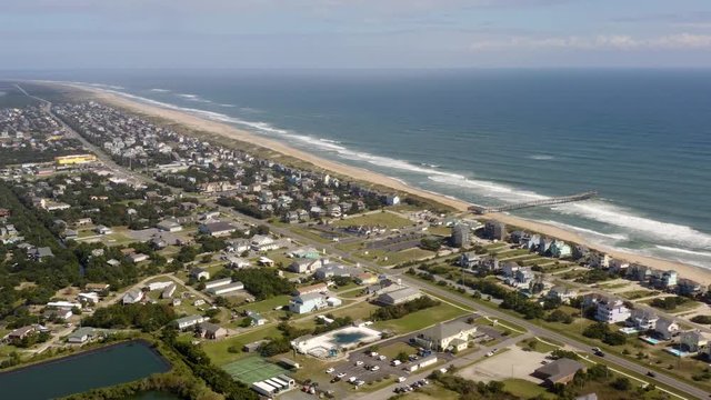 124 Aerial view of town, ocean and beach. Flying backward. 4k