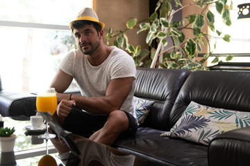 Man Relaxing on Sofa in Hotel Lobby Bar