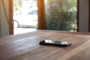 A single mobile phone on wooden table