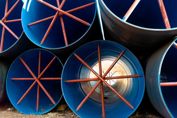 Stack of big blue water pipes used as water tunnel in irrigation project. (1)