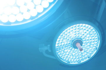 Two surgical lamps in operation room take with art lighting and blue filter