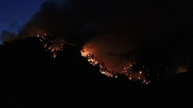 Hillside a night on fire.