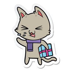 sticker of a cartoon hissing cat with christmas present