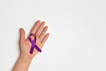 Hand holding Purple ribbons on a white background. World epilepsy day.