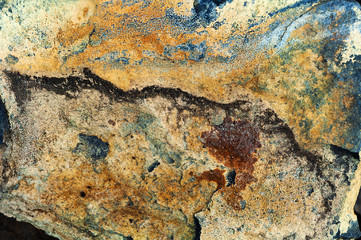 Background from a wild stone, iridescent sandstone close up