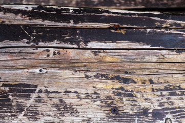 Textural background of old worn dark pine boards close up