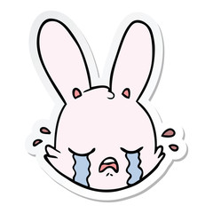 sticker of a cartoon crying bunny face