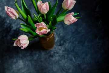 bunch of beautiful easter tulips. dark background.Beautiful spring bouquet.Grunge background with pink tulip flowers. Dark gray template with bouquet.billboard or Web banner With Copy Space for design