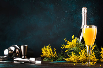 Low alcohol cocktail mimosa with orange juice and cold dry champagne or sparkling wine in glasses,...