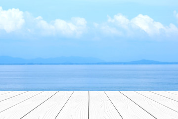 Empty white marble table over blur blue sea and sky in summer background, product display montage background, banner