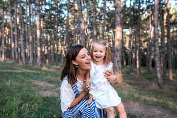 Fototapeta premium Happy mother and daughter singing together outdoors.